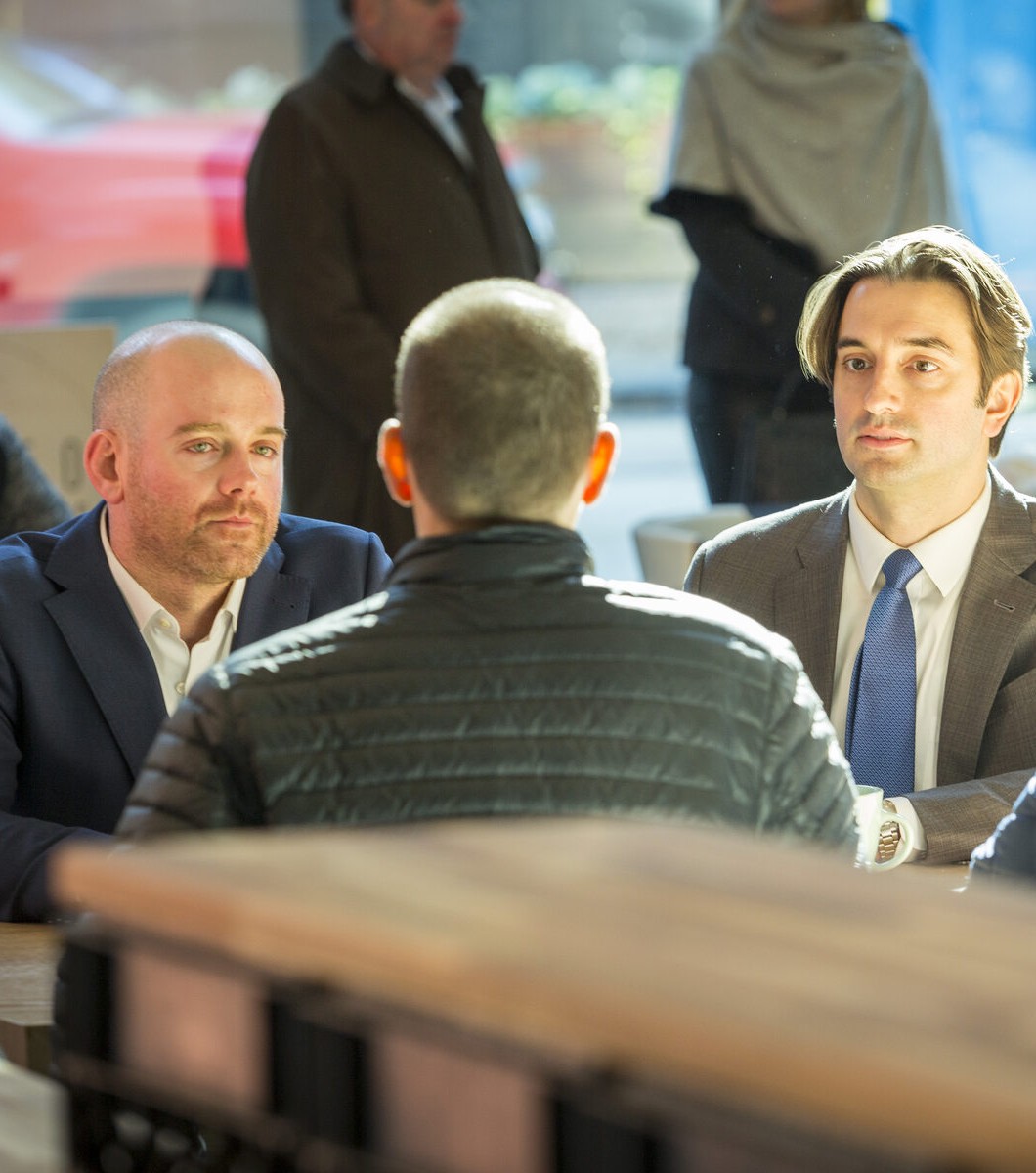 Attorneys Alan Spivak and George Sakellariou meeting with a client